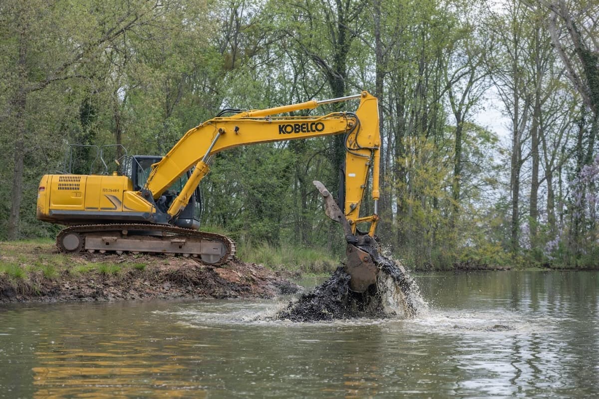 Professional pond dredging equipment at work